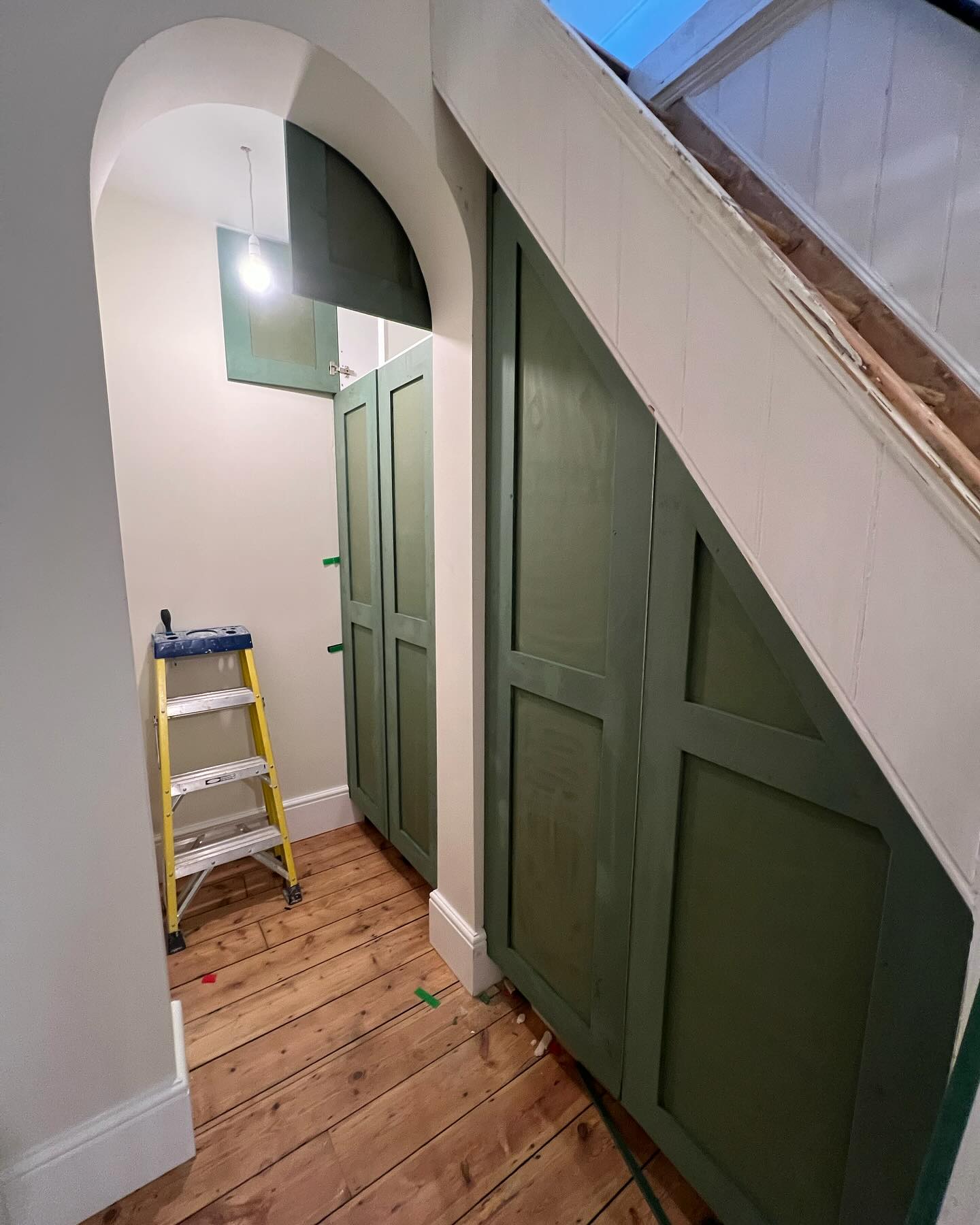 Green doors for storage area under the stairs in Rochester, Kent