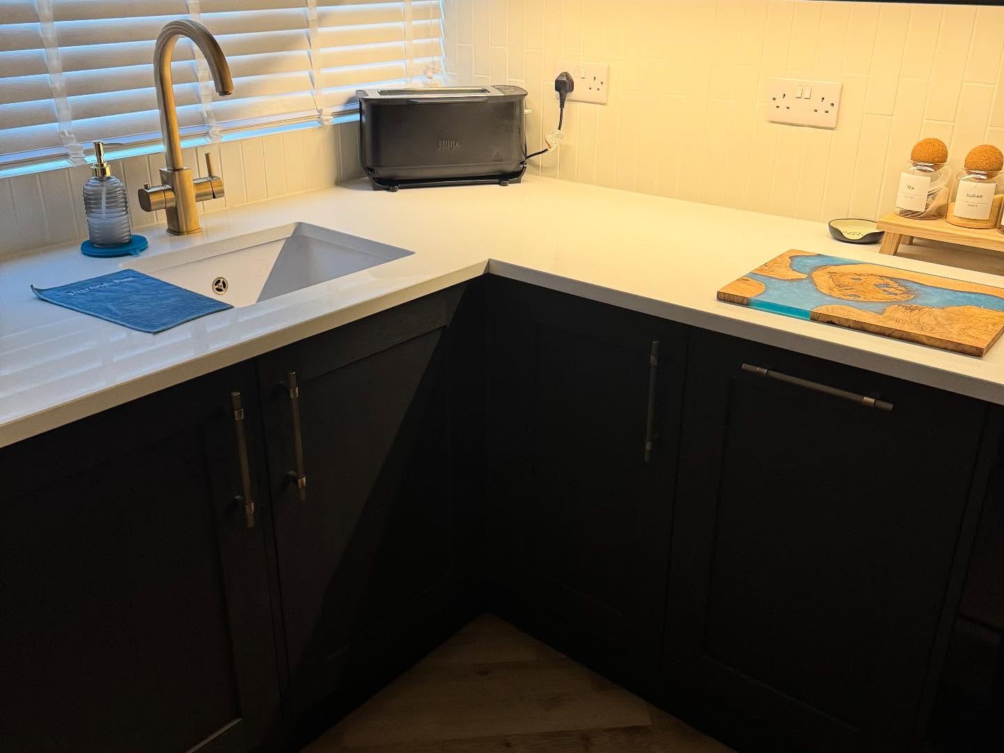New kitchen with white worktops and black cupboards in Rochester, Kent